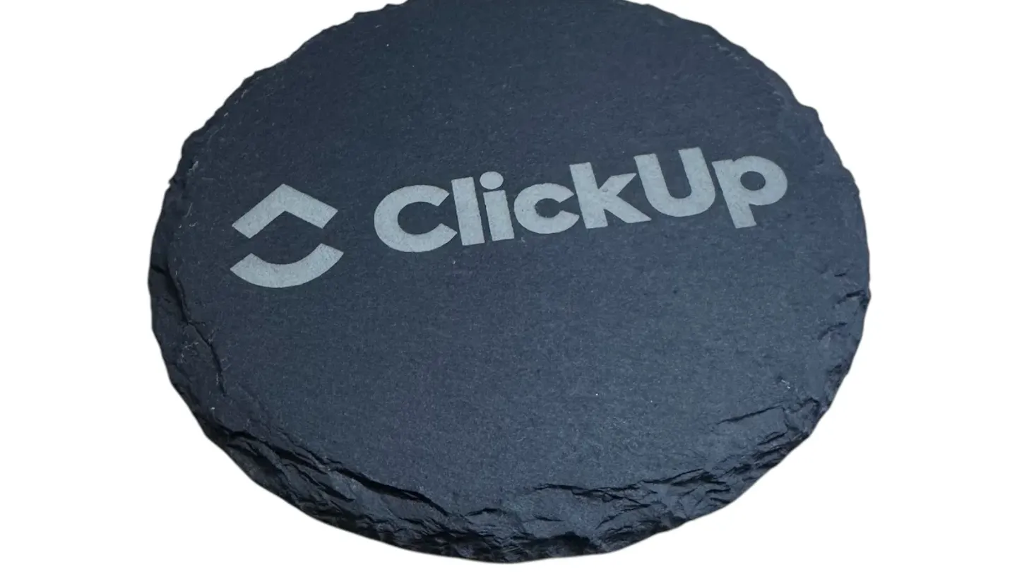 Round black stone branded with the ClickUp name
