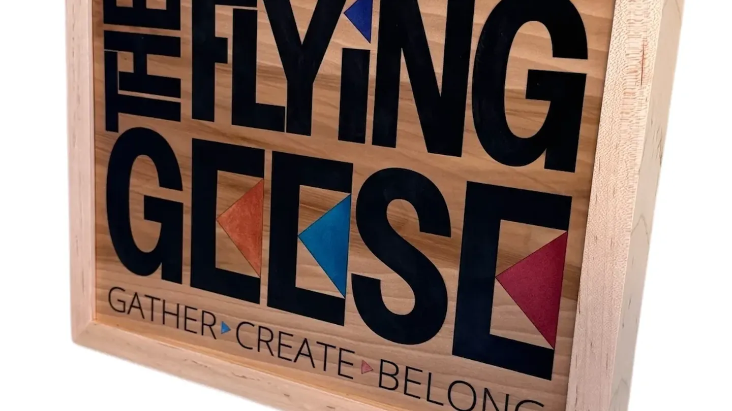 Decorative wooden Flying Geese sign with colorful geometric birds